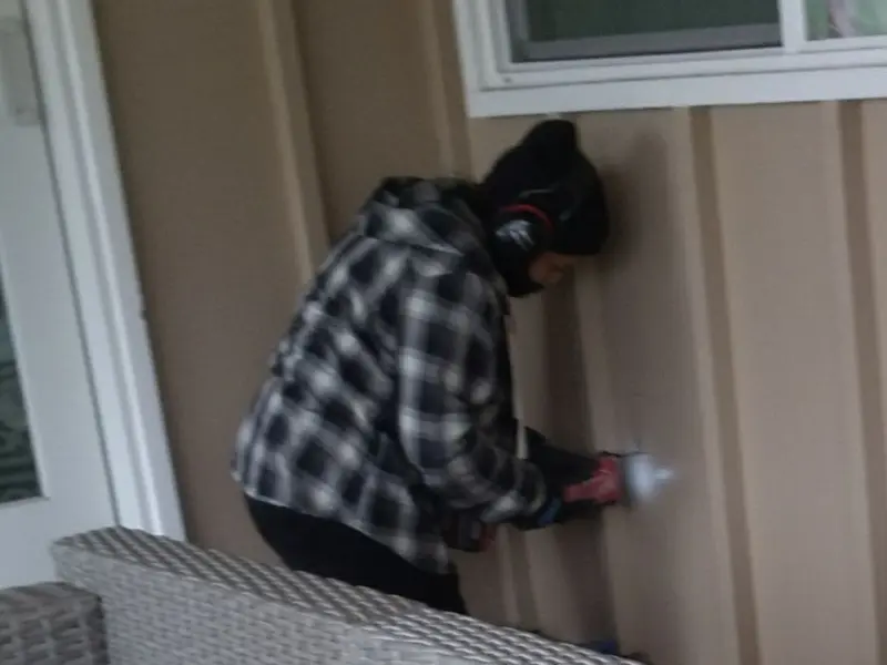 Professional electrician installing an exterior outlet in Standish